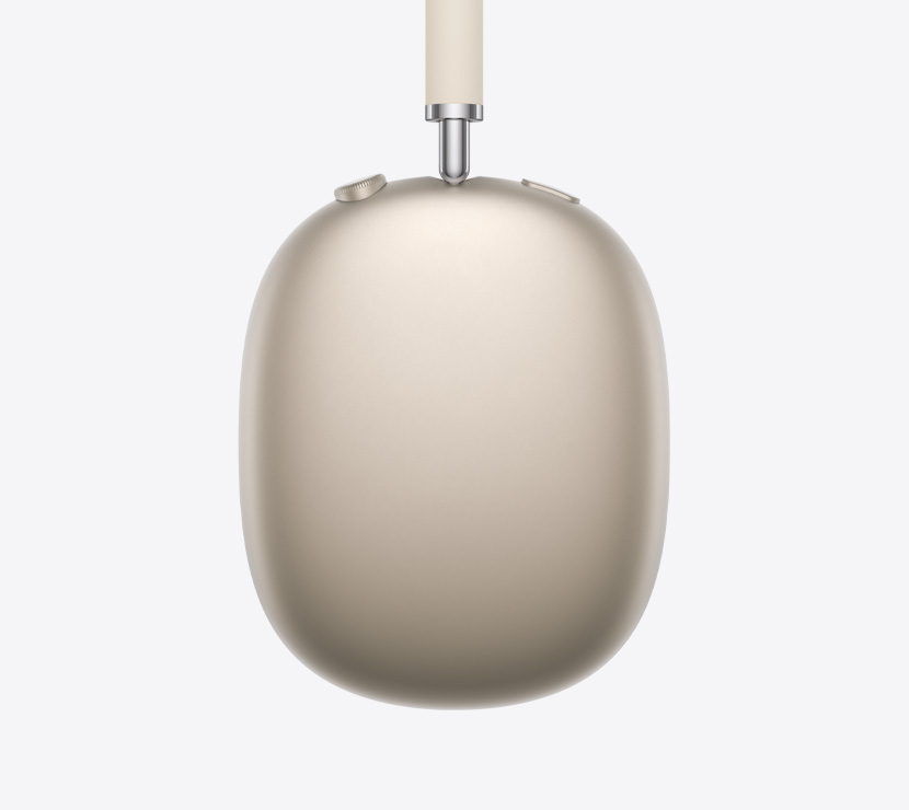 星光色 AirPods Max 2 耳机的侧面外观，展示伸缩套杆、耳垫、数码旋钮和噪声控制按钮的细节。