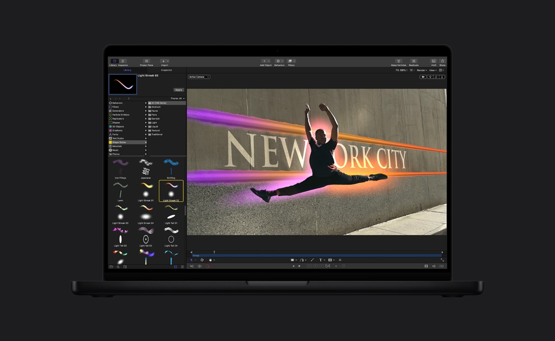 16 英寸 MacBook Pro 屏幕画面显示一位男性舞者跃在半空，身体环绕着光晕，展示绘画工具功能。