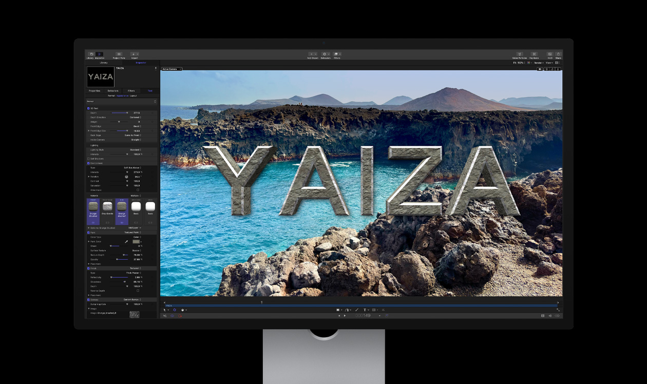 Mac Studio 显示器，屏幕显示在岩石海岸线的画面之上创建的标题效果，标题文字为 Yaiza。