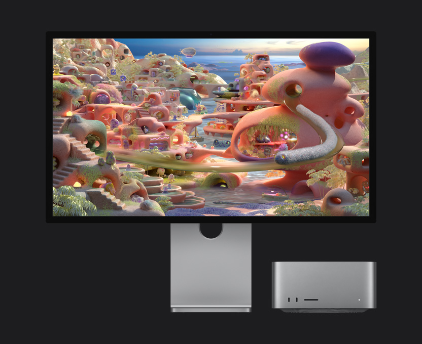 Studio Display XDR 显示一个卡通场景，Mac Studio 收置在下方；一只长得像蠕虫的生物看似正钻出隧道，在屏幕上移动。